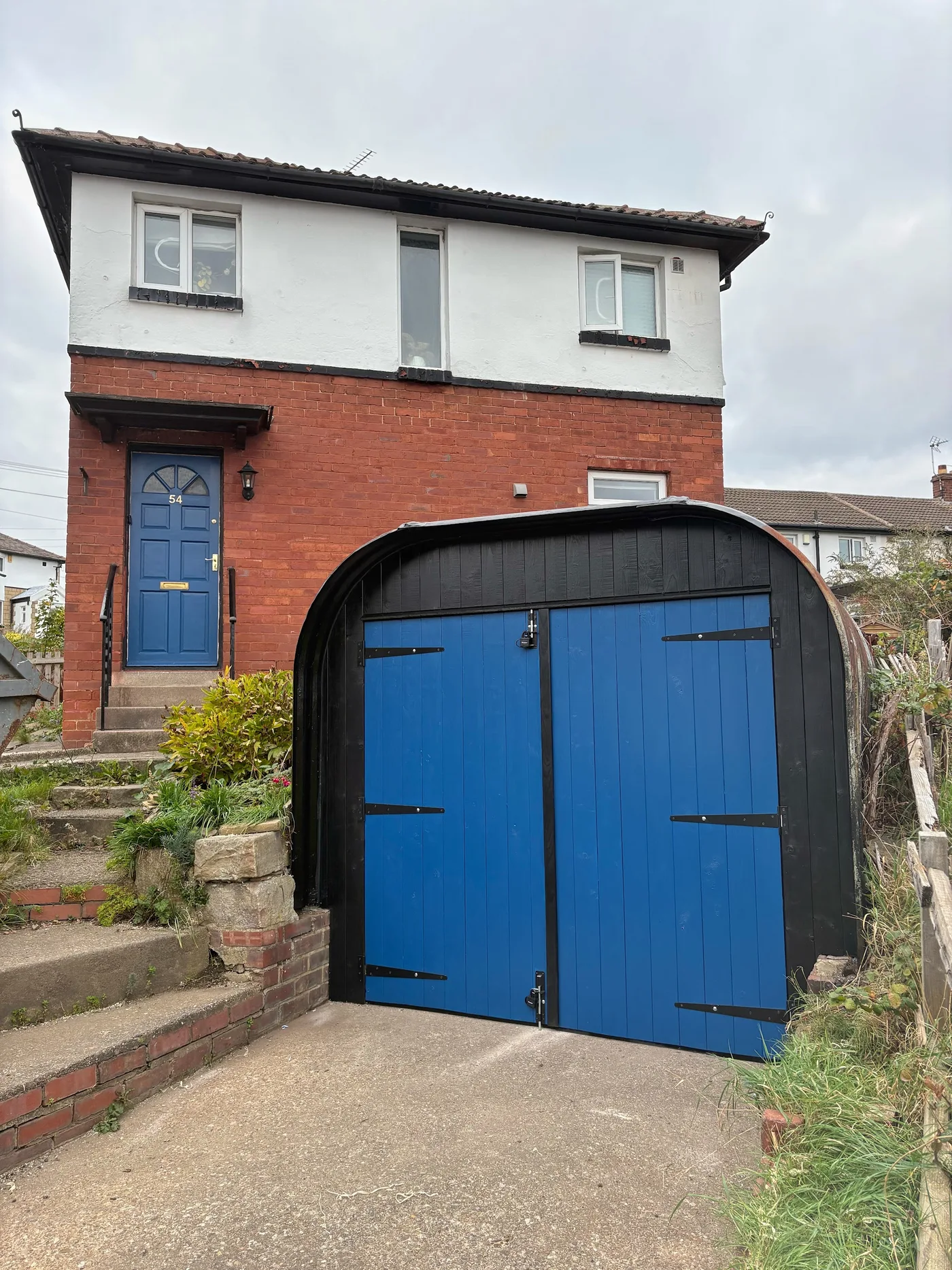 Blue timber doors with black iron hinges